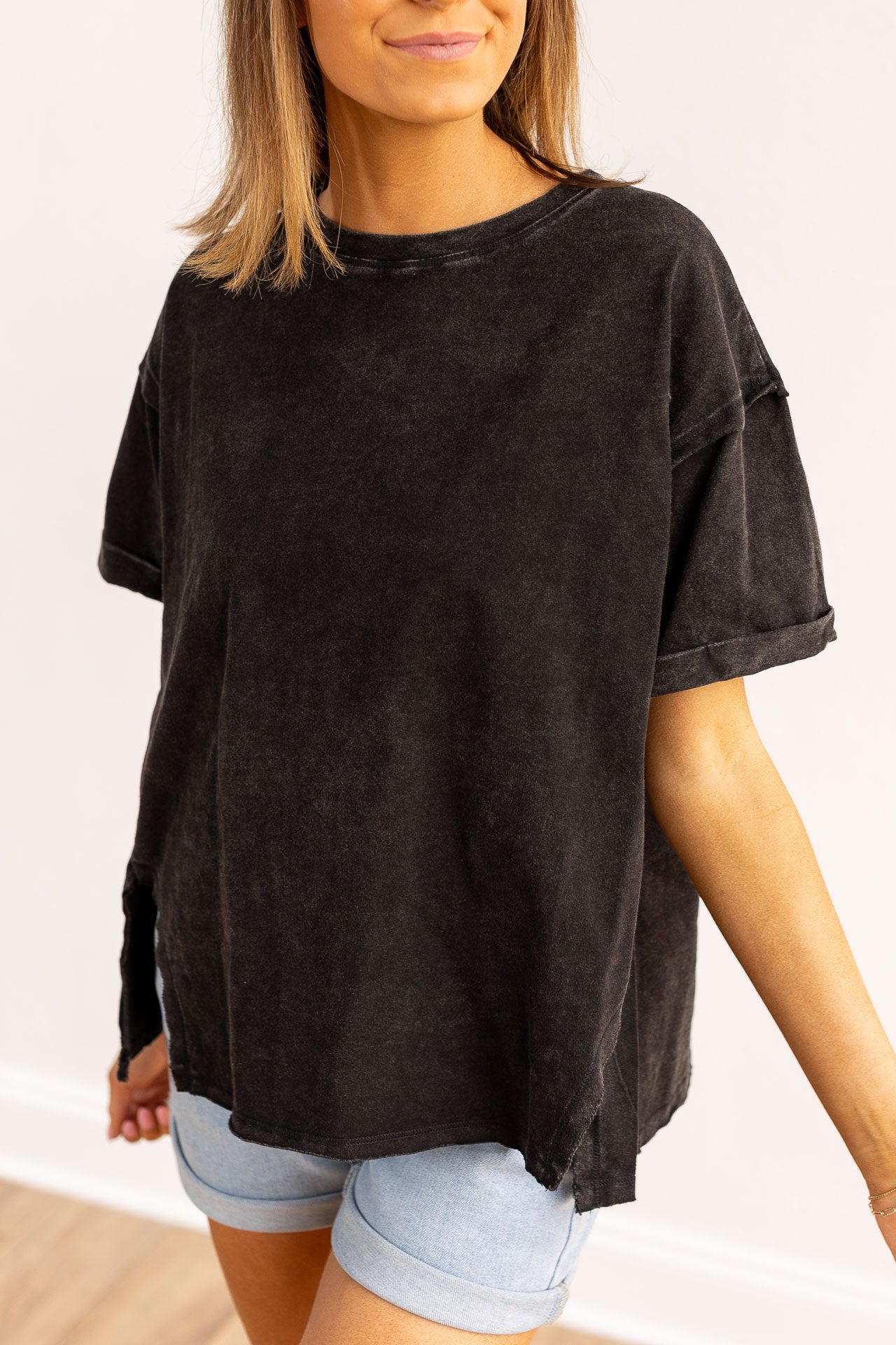 Black side slit crop with raw stitching.